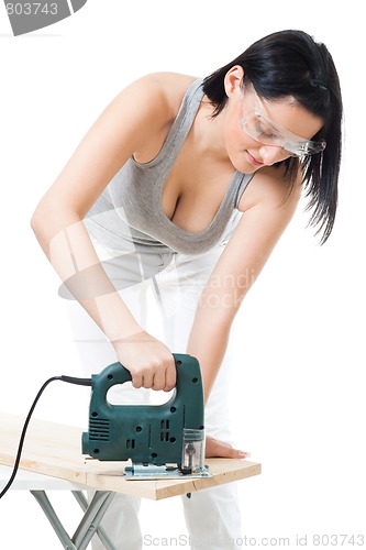 Image of Woman cut wood plank with electric saw