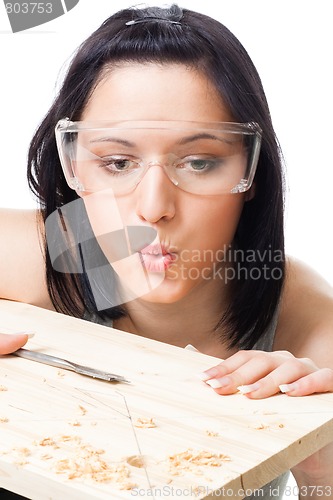 Image of Woman blow away scobs after drilling