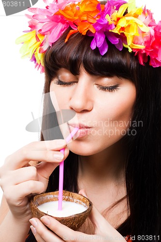 Image of Young woman drink coconut milk from shell