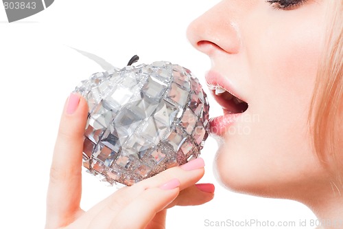 Image of woman taste apple with her mouth