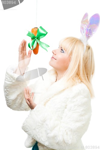 Image of Woman in rabbit costume stretch out for carrot