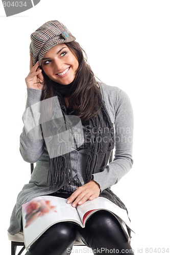 Image of Positive happy young woman with magazine