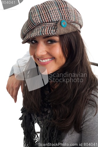 Image of Young woman in cap smile and turn back
