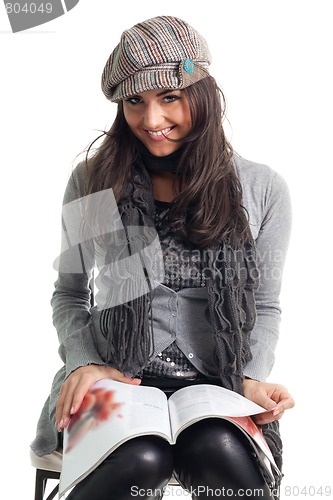 Image of Stylish young woman read magazine