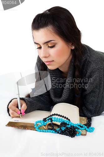 Image of young woman write memories