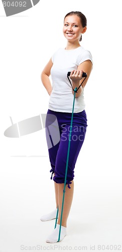 Image of Young woman workout with expander