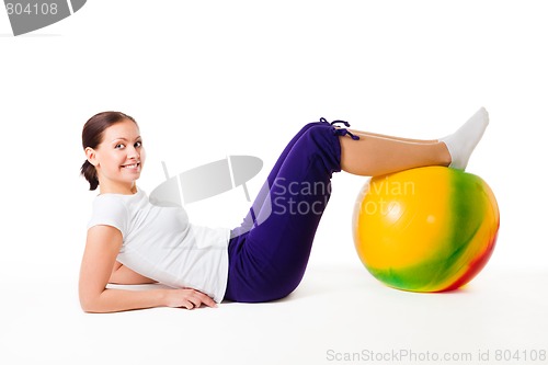 Image of Woman doing fitness exercises with ball