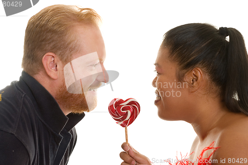 Image of Two people share a candy