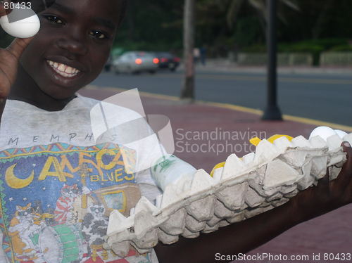 Image of Child selling eggs