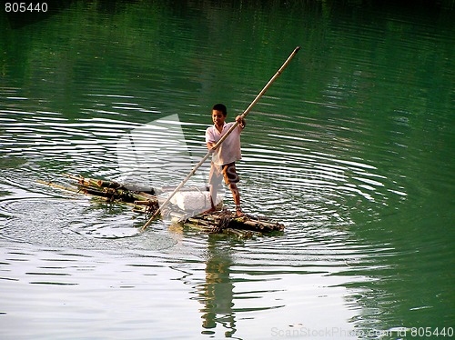 Image of young thai on a wooden raft