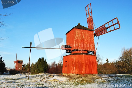 Image of Two Red Wooden Windmills