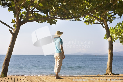 Image of Woman with strawhat at the sea