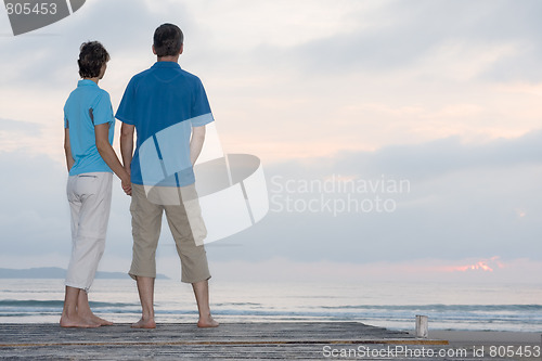 Image of Mature couple contemplating the sunrise