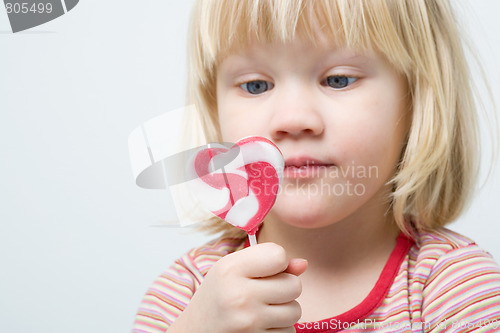 Image of Cute little girl with a lollipop