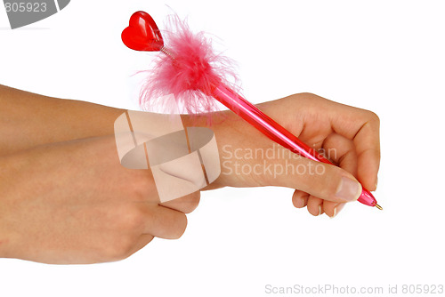 Image of Hands writing on white paper