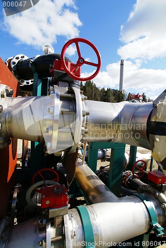 Image of  industrial pipelines on pipe-bridge against blue sky