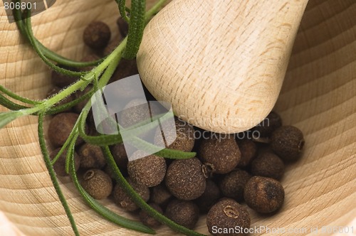 Image of Mortar with fresh herbs and allspice berries