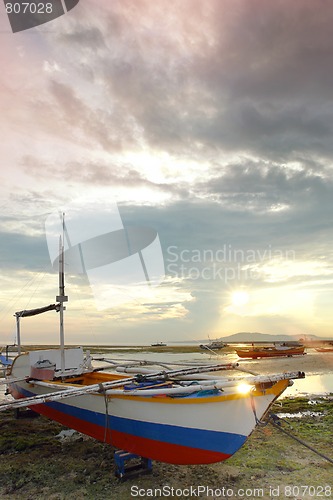 Image of Fishing boat on sunset beach