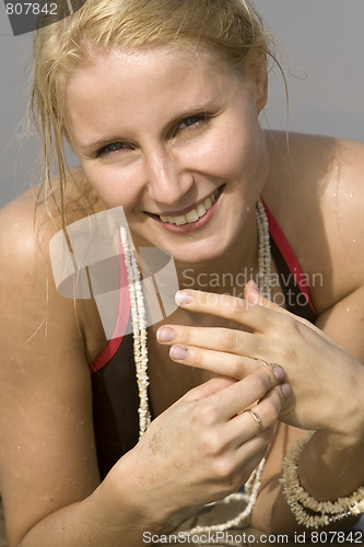 Image of good looking woman rolling around in the surf