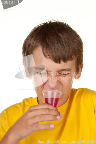Image of boy drinking medicine on white