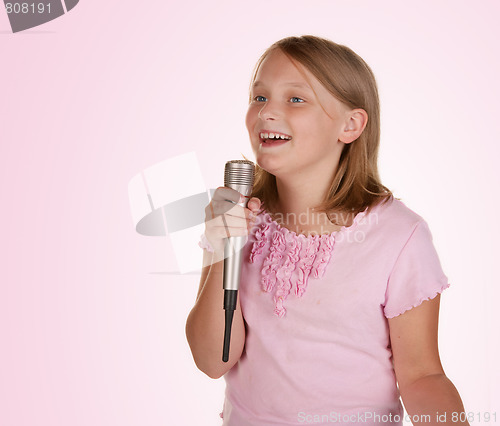 Image of young girl singing karaoke on white