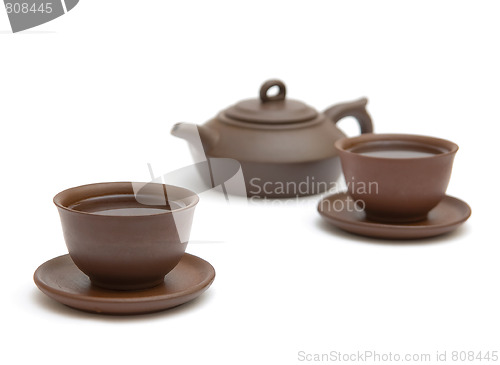 Image of Two  cups of tea and brown teapot