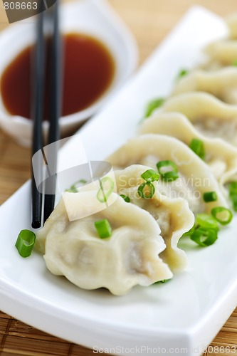 Image of Steamed dumplings and soy sauce