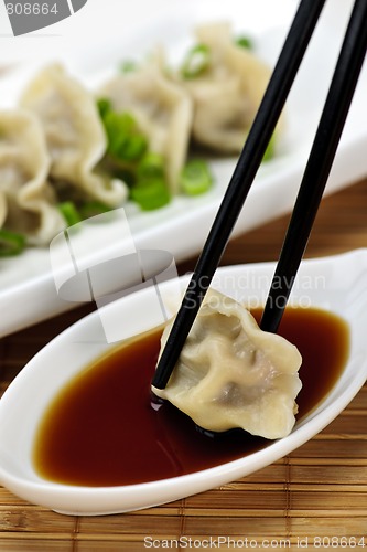 Image of Steamed dumplings and soy sauce