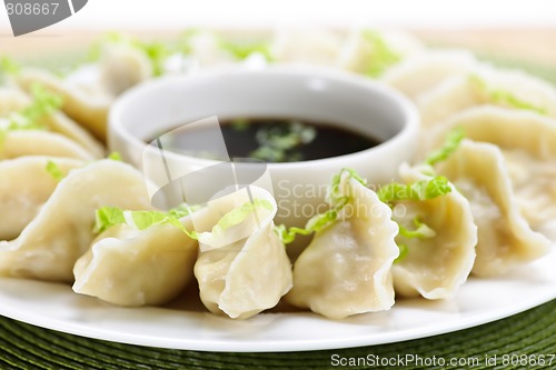 Image of Steamed dumplings and soy sauce