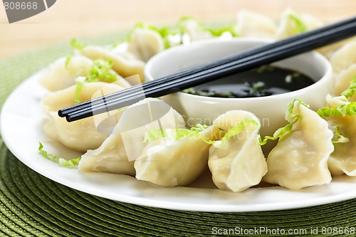 Image of Steamed dumplings and soy sauce