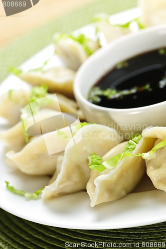 Image of Steamed dumplings and soy sauce