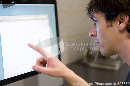 Image of Man Pointing at Computer Screen