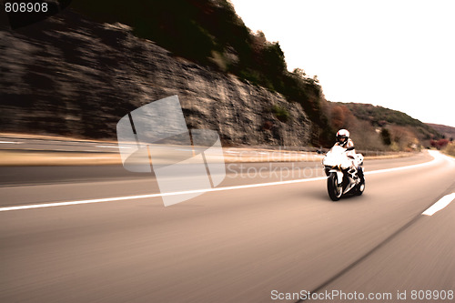 Image of Speeding Motorcycle Woman