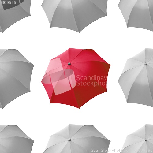 Image of Red umbrella among white