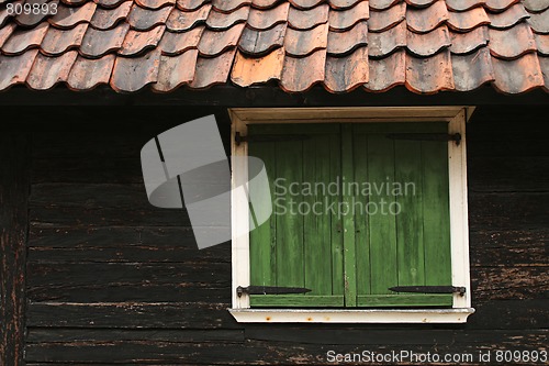 Image of cabin window and tile roof