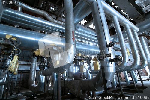 Image of Pipes, tubes, machinery and steam turbine at a power plant
