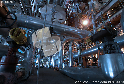 Image of Pipes, tubes, machinery and steam turbine at a power plant