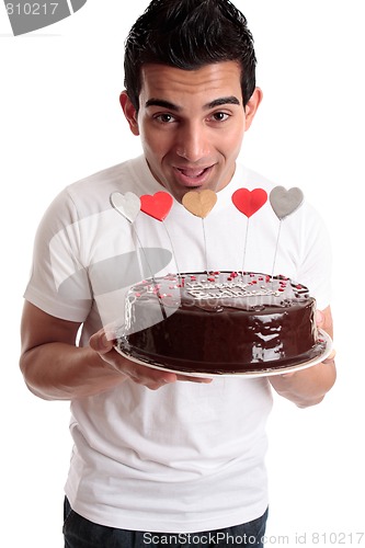 Image of Cheeky man with a birthday cake