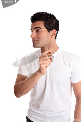 Image of Man spraying perfume cologne to his neck