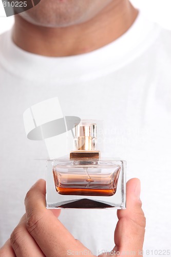 Image of Man holding perfume aftershave