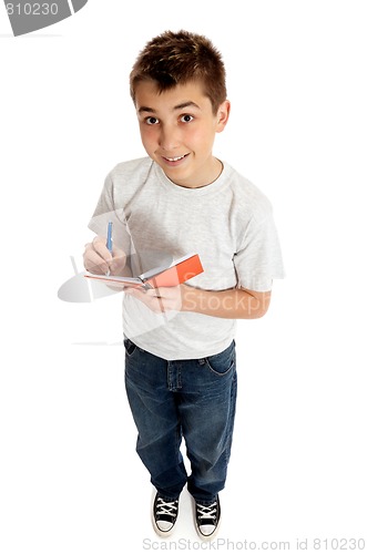 Image of Boy looking up from a book and smiling