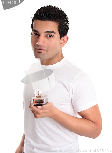 Image of Adult male holding a bottle of aftershave or men's fragrance