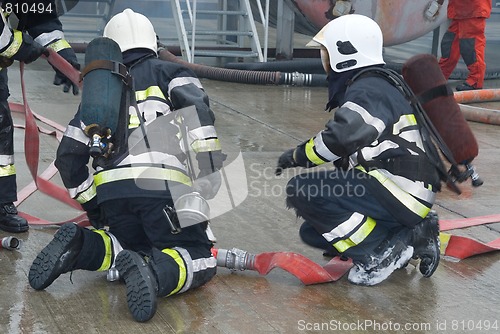 Image of Fire fighters preparing hoses