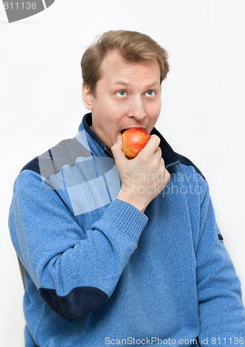 Image of Man blond eats apple