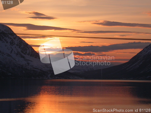 Image of Dawn behind sea and mountains