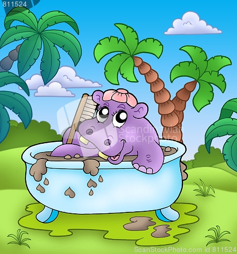 Image of Cute hippo taking mud bath