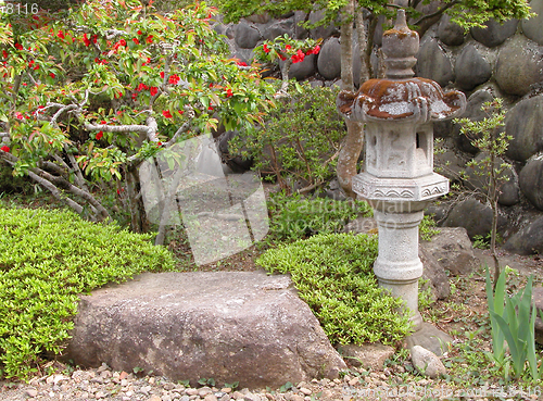 Image of Japanese garden with old stone lantern