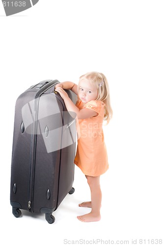 Image of Little girl and suitcase in studio