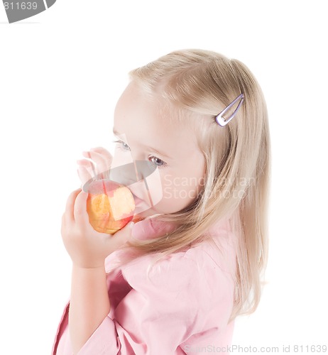 Image of Little girl eating peach in studio