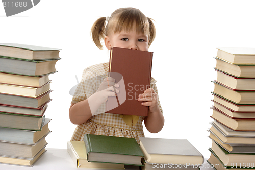 Image of Little girl hiding behind the book, back to school